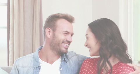 Happy Multicultural Couple Enjoying Relaxed Time on Living Room Sofa