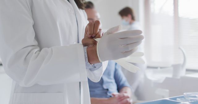 Doctor Preparing for Medical Examination with Patient in Background - Download Free Stock Images Pikwizard.com