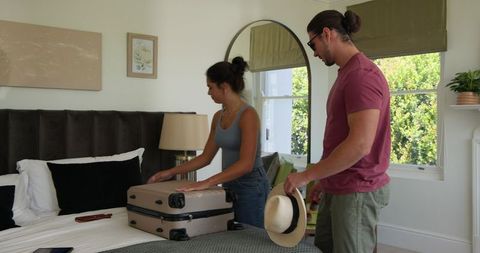 Couple Packing for Wedding Celebration Together