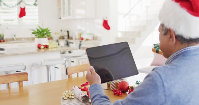 Senior Man Video Calling on Tablet During Christmas Celebration at Home - Download Free Stock Images Pikwizard.com