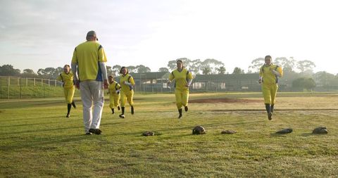 Baseball Team Practicing on Field at Sunrise