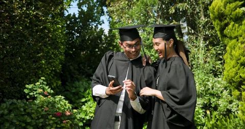 Graduating Students Celebrating with Selfie in Lush Garden