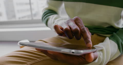 Businessman Uses Digital Tablet in Modern Office Setting