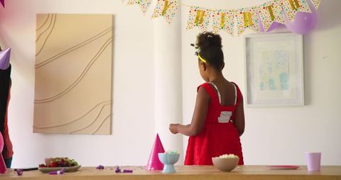 Father decorating birthday party room with daughter