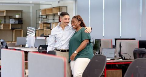 Colleagues Sharing Moment of Celebration in Modern Office