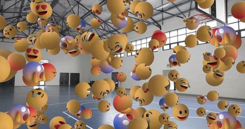 Floating 3d emoji orbs filling basketball court surrounding solitary man in dark clothes