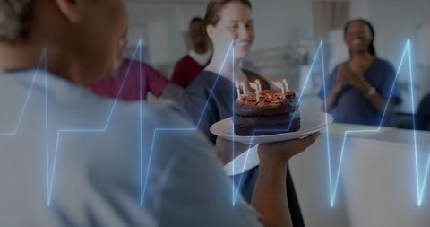 Medical staff celebrating birthday with cake in hospital