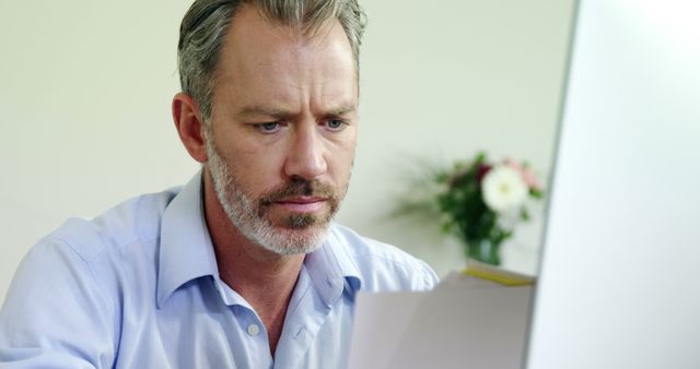 Man Analyzing Documents on Computer - Download Free Stock Images Pikwizard.com