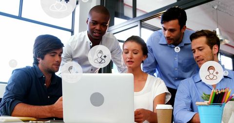 Diverse Coworkers Collaborating on Laptop with Digital Overlays