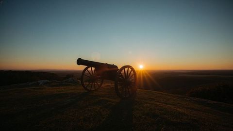Cannon Silhouette on Hill During Stunning Sunset