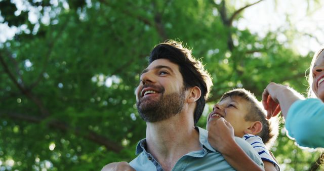 Joyful Father and Son Bonding Outdoors in Lush Green Park - Download Free Stock Images Pikwizard.com