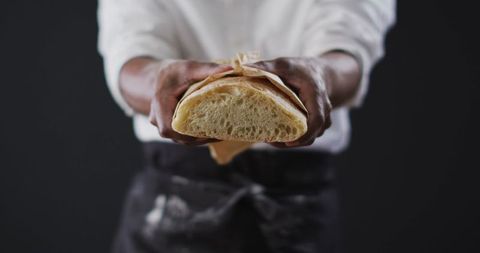 Chef Holding Freshly Baked Bread with Rustic Look