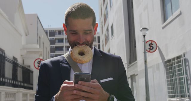 Businessman Eating Bagel Using Smartphone Urban Street - Download Free Stock Images Pikwizard.com