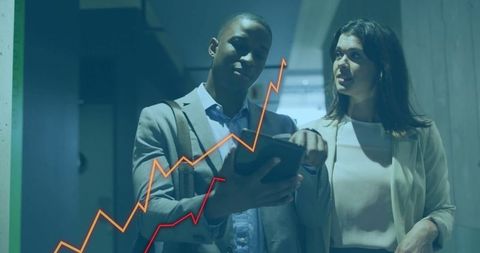 Business professionals analyzing digital financial data with rising graph