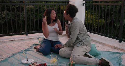 Couple Enjoying Romantic Rooftop Picnic at Sunset