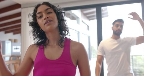 Relaxed Couple Practicing Yoga at Home with Natural Light
