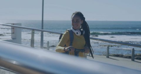 Woman Enjoying Beach Walk with Headphones and Backpack