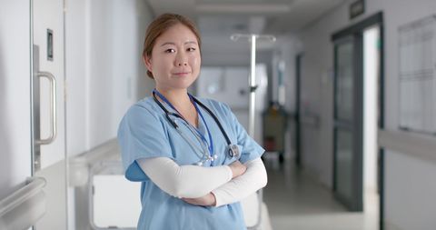 Confident Female Doctor in Hospital Uniform Standing Indoors - Download Free Stock Images Pikwizard.com