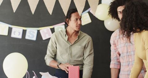 Multiracial Coworkers Celebrating Office Baby Shower Clean-up