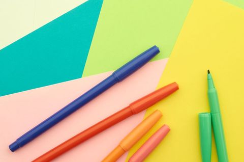 Colorful markers on geometric colorful background