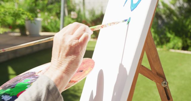 Elderly Person Painting on Canvas Outside on Sunny Day - Download Free Stock Images Pikwizard.com