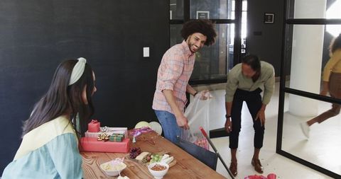 Colleagues Cleaning Office after Baby Shower Celebration