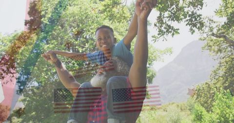 Joyful Father and Son Outdoors Amidst Scenic Landscape