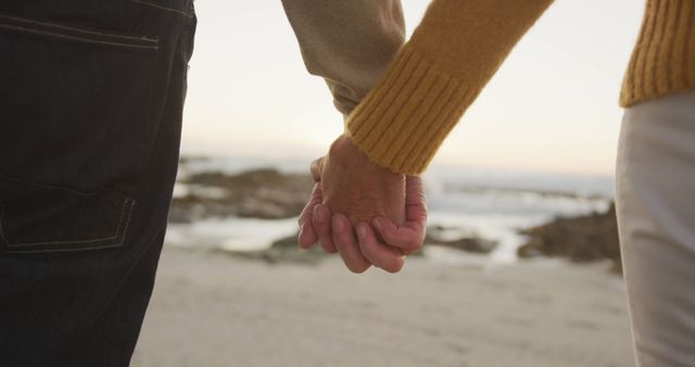 Senior caucasian couple holding hands at seaside on sunny day - Download Free Stock Photos Pikwizard.com