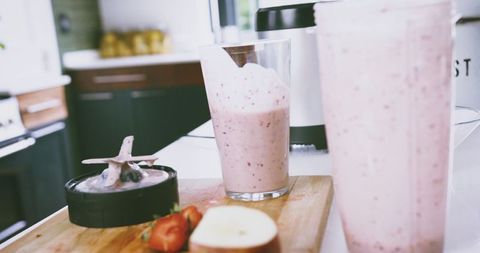 Refreshing Fruit Smoothie Preparing on Modern Kitchen Counter