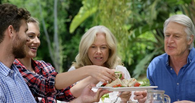 Family Enjoying Outdoor Lunch Together in Garden - Download Free Stock Images Pikwizard.com