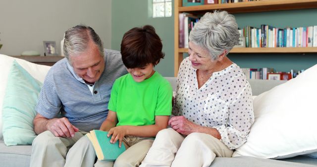 Happy Grandparents Reading Book with Grandson on Couch at Home - Download Free Stock Images Pikwizard.com