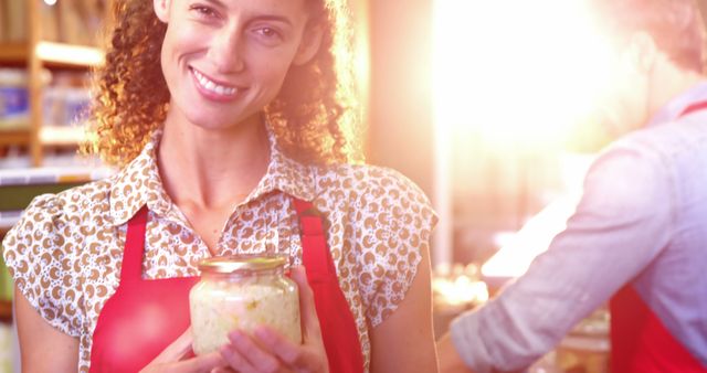 Portrait of smiling female staff holding jar in super market 4k