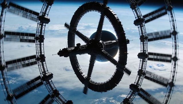 Rotating toroidal space station orbiting earth with hurricane vortex below, futuristic habitat