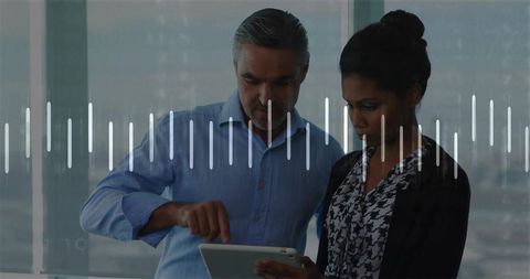 Business professionals collaborating on tablet with digital waveform overlay in office skyline