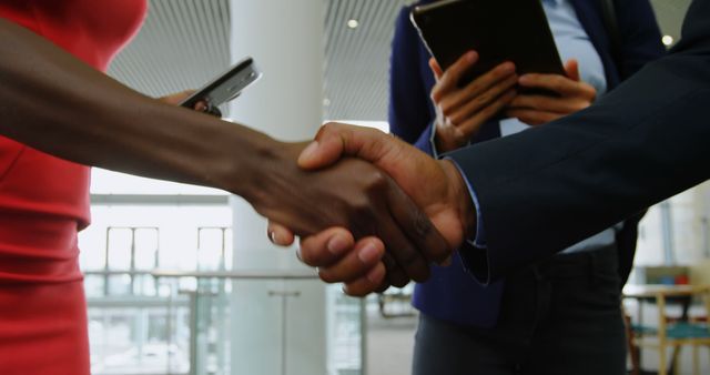 Business Professionals Shaking Hands in Modern Office Building - Download Free Stock Images Pikwizard.com