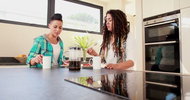 Two Friends Enjoying Breakfast in Modern Kitchen Setting - Download Free Stock Images Pikwizard.com