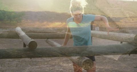Woman tackling outdoor obstacle course on sunny day