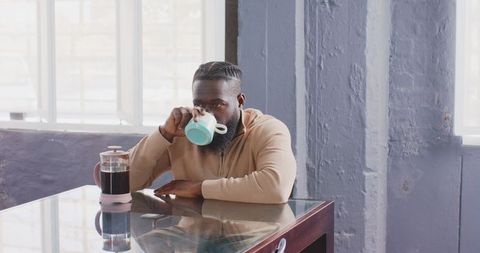Businessman taking relaxing coffee break in modern office