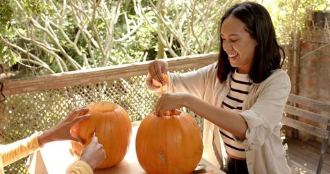 Smiling Friends Carving Pumpkins for Halloween Celebration