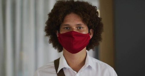 Young Professional with Red Mask in Modern Interior