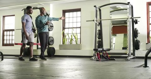 Trainer coaching client in eclectic gym space with modern equipment