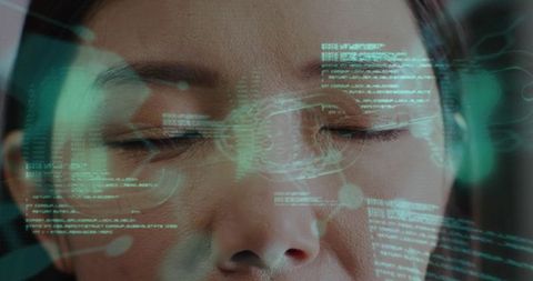 Chinese woman undergoing biometric facial scan displaying cyan holographic hud and data