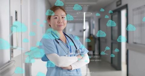 Korean nurse standing in hospital wearing blue scrubs and stethoscope showing cloud icons