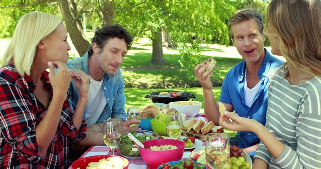 Friends Enjoying Picnic in Sunny Park - Download Free Stock Images Pikwizard.com