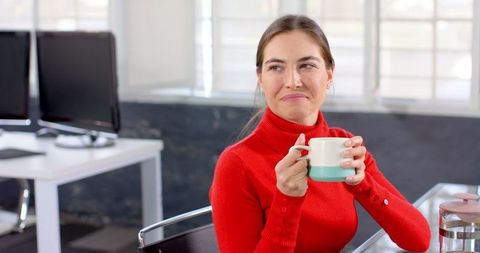 Woman Relaxes with Coffee During Office Break