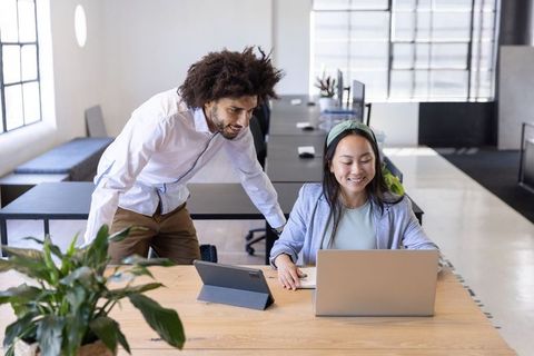 Diverse Coworkers Collaborating in Open-Plan Office Environment