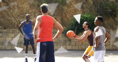 Team Players Engaged in Intense Outdoor Basketball Game on Court