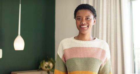Smiling woman in cozy home environment with minimalist decor
