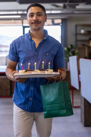 Festive office birthday celebration with cupcakes and gifts