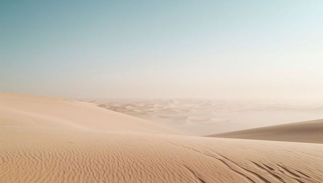Smooth sand dunes stretching across desert landscape